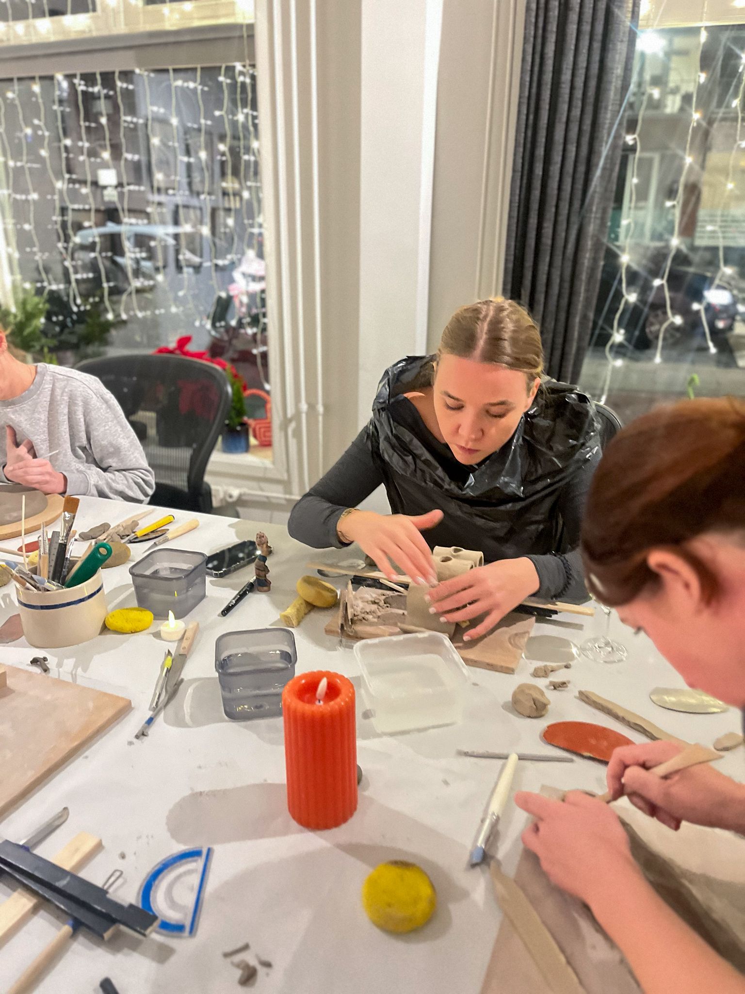 The offline atelier space with participants working at the table