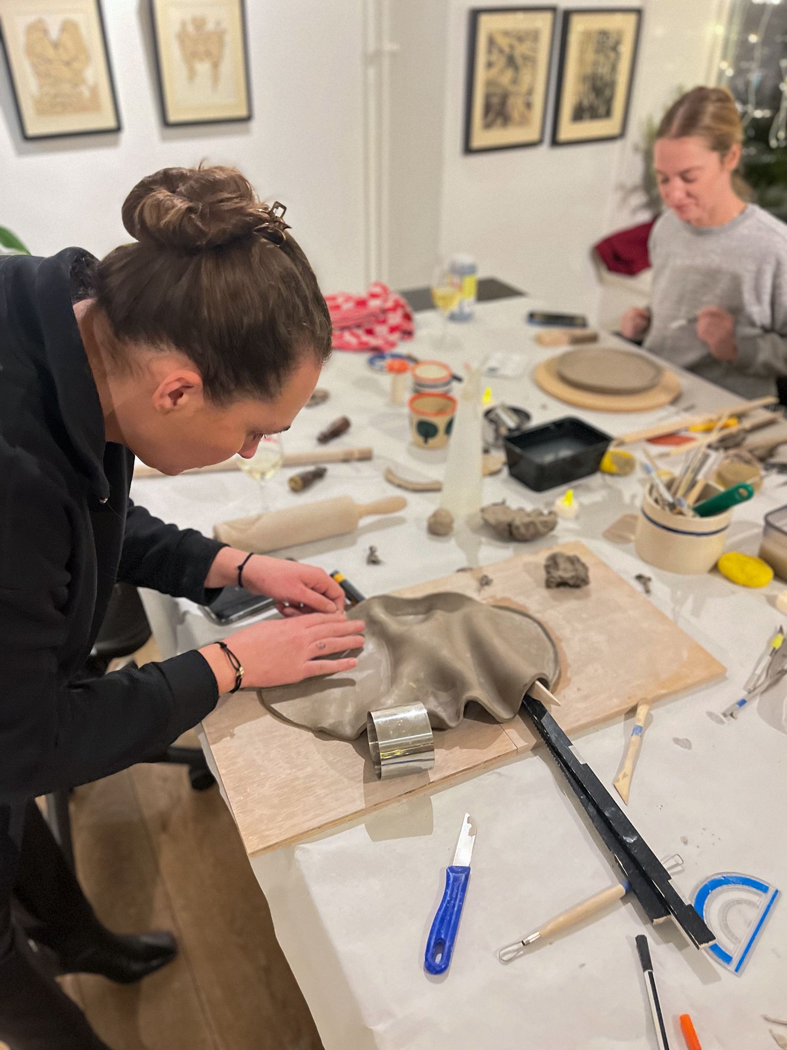 Ceramic workshop in the studio with participants shaping clay